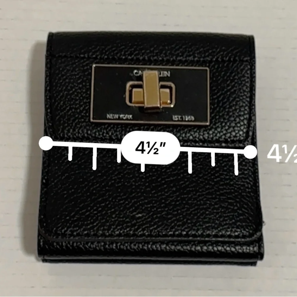 Calvin Klein black trifold wallet with a gold-tone metal closure